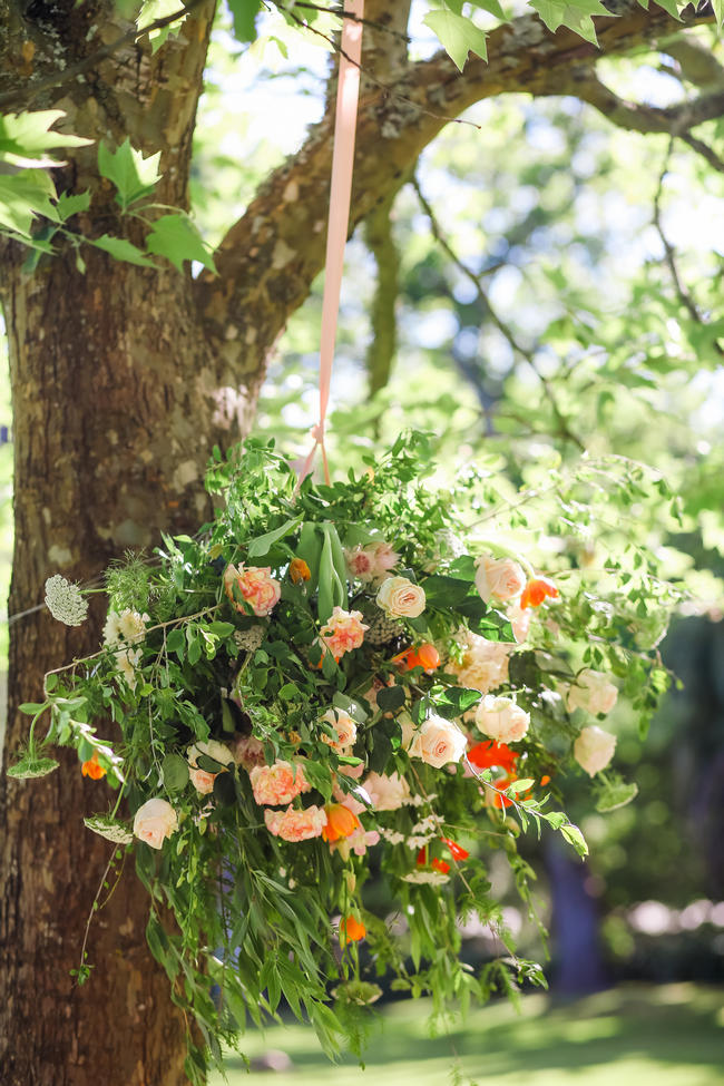 Hanging floral chandelier // Whimsical Garden Wedding flowers in Peach, green and silver Grey // Nikki Meyer Photography