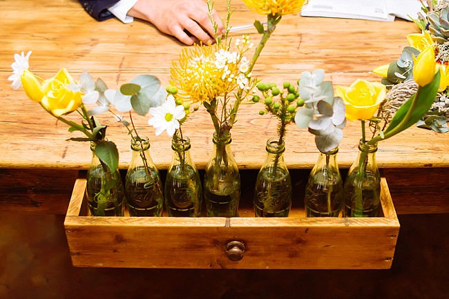 Vintage bottles with single flowers in wooden crate // Yellow and Grey DIY Vintage Wedding // Miracles Photo