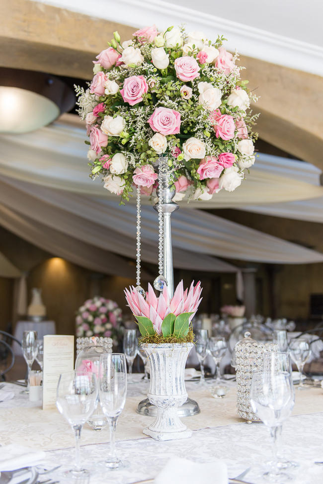 Pink, blush and cream wedding reception table details with stunning King Protea // Lightburst Photography