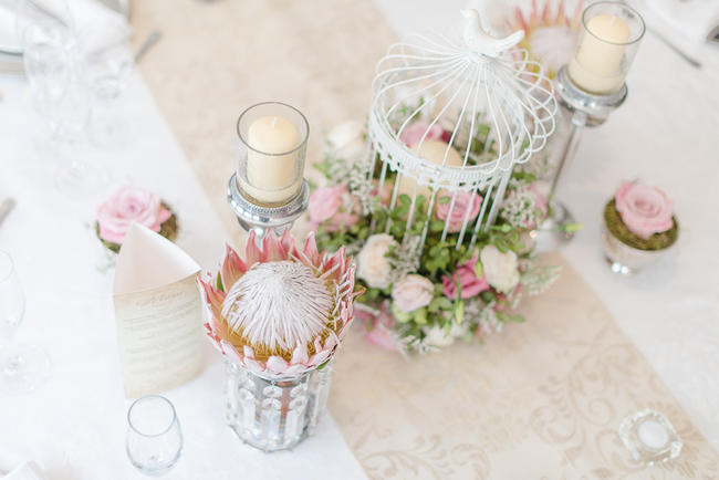 Pink, blush and cream wedding reception table details with stunning King Protea // Lightburst Photography