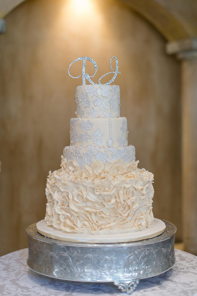 Cream and white ruffled wedding cake with glitter cake topper