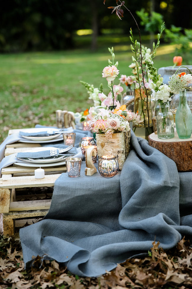  A pretty pallet picnic table using grey hessian burlap runner, filled with rustic decor elements, mercury votives, wood slabs and peach blooms in mix and match vases. Rustic Garden Picnic Wedding // Nikki Meyer Photography