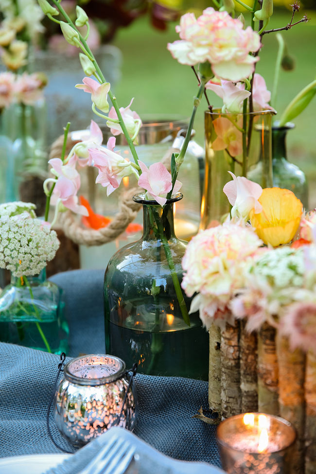 A pretty pallet picnic table using grey hessian burlap runner, filled with rustic decor elements, mercury votives, wood slabs and peach blooms in mix and match vases. Rustic Garden Picnic Wedding // Nikki Meyer Photography