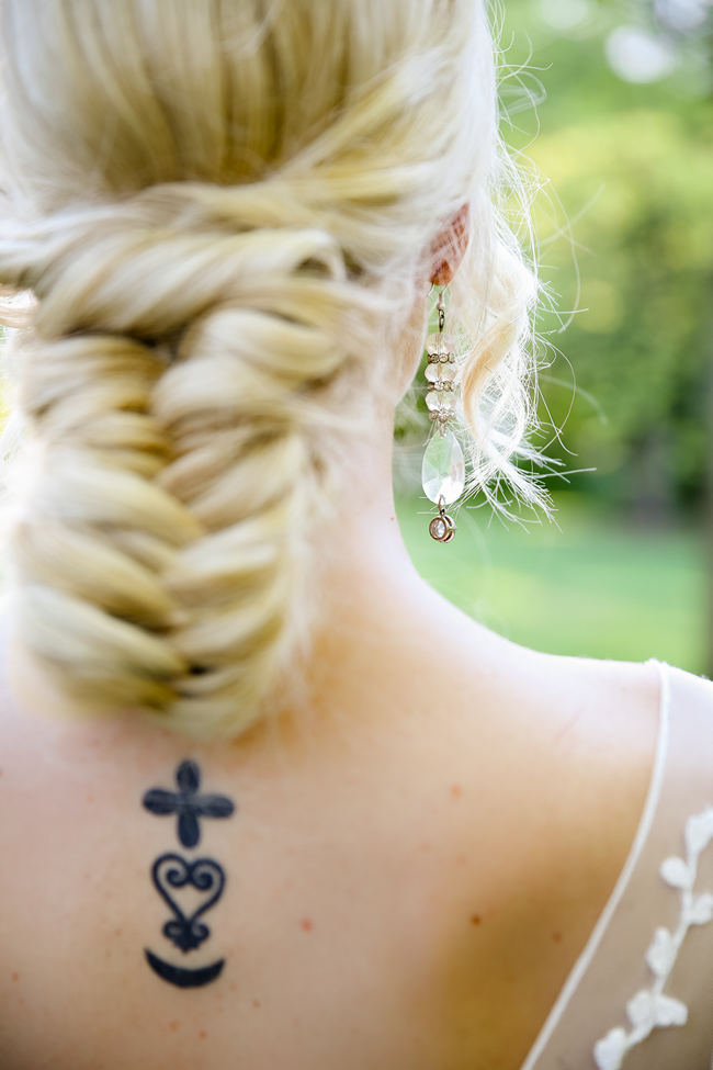 A deep V style Lace back wedding dress shows off tattoo. Lovely Rustic Garden Picnic Wedding // Nikki Meyer Photography