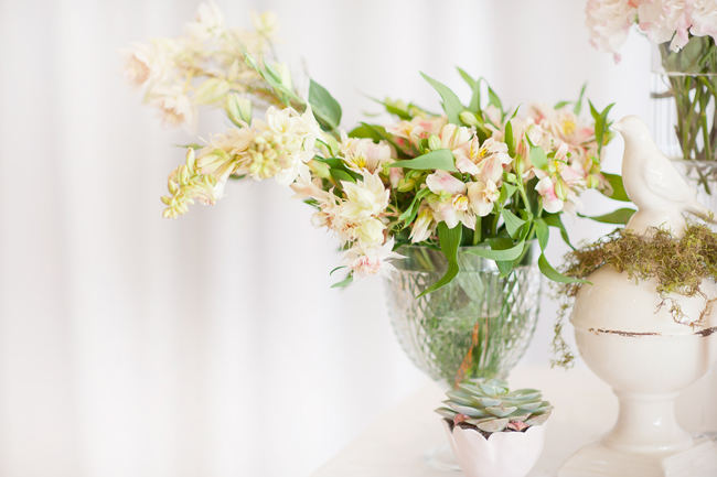 The romantic, ruffled layers of this strapless sweetheart wedding dress and messy bridal upstyle hairdo looking amazing with a backdrop of whimsically floating gold chairs.