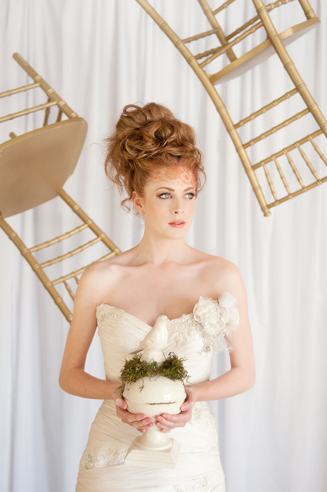 The romantic, ruffled layers of this strapless sweetheart wedding dress and messy bridal upstyle hairdo looking amazing with a backdrop of whimsically floating gold chairs.