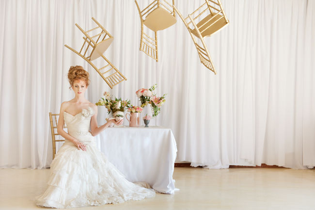 The romantic, ruffled layers of this strapless sweetheart wedding dress and messy bridal upstyle hairdo looking amazing with a backdrop of whimsically floating gold chairs.