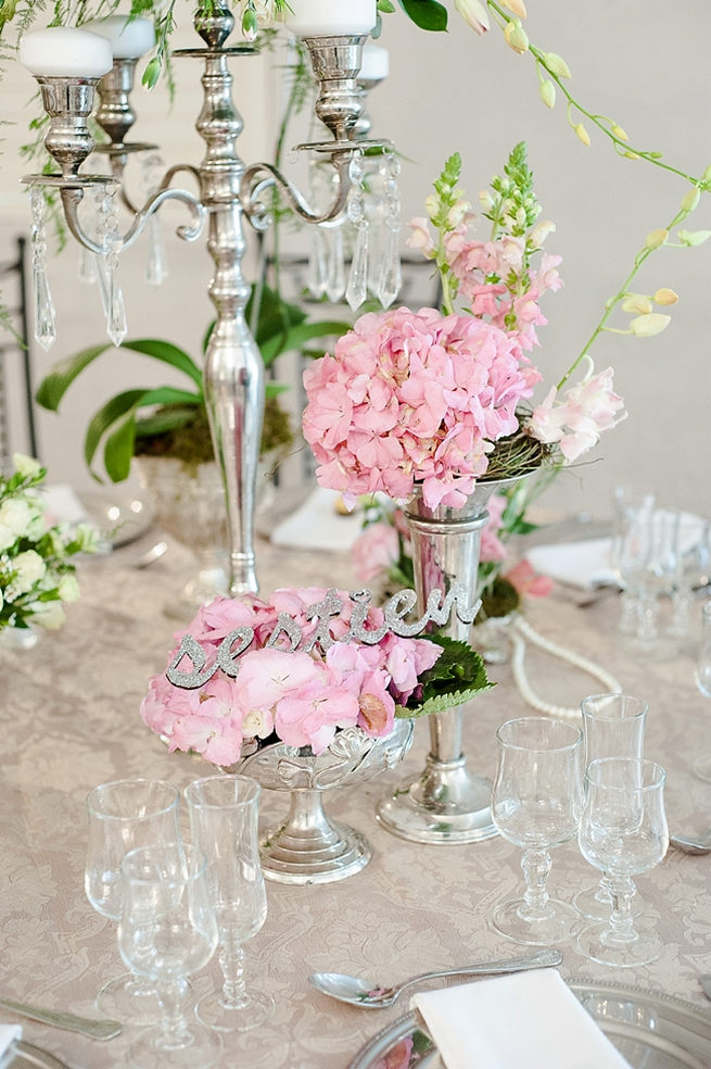 Blush and pink wedding flowers in silver urns and vases on wedding reception tables: hydrangea, roses, lisanthius and leatherleaf ferns // D’amor Photography