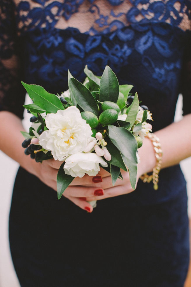 Green, white and navy bridesmaids bouquet with greens and blue berries wrapped in navy ribbon