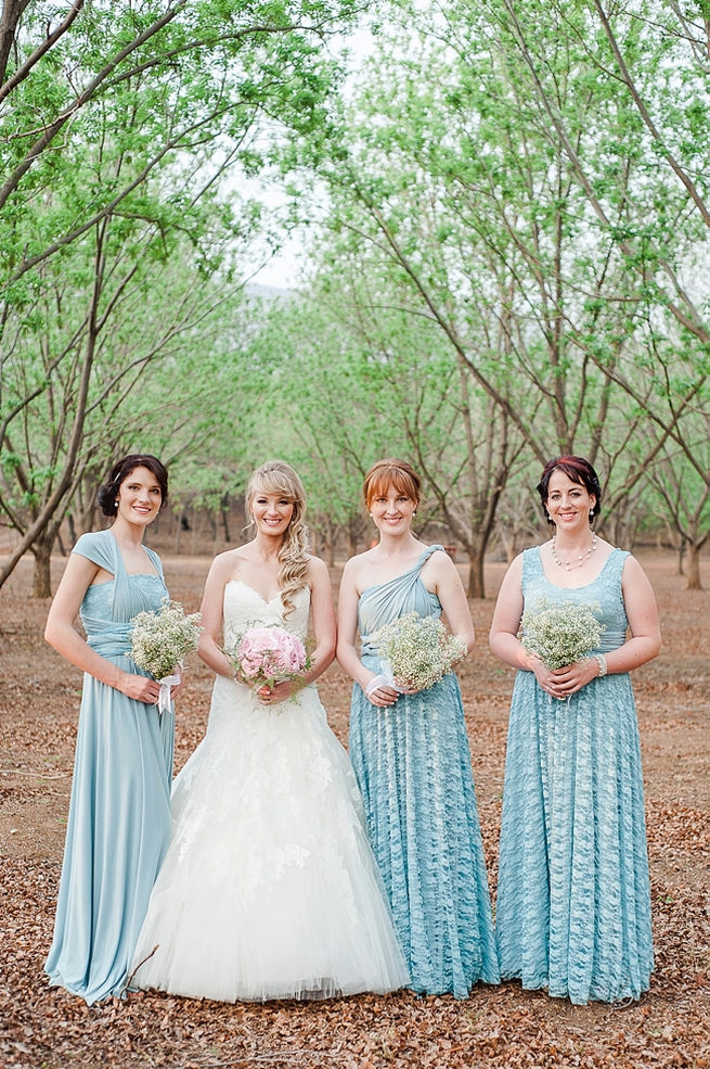 Bridesmaids wearing mismatched blue dress, with babys breath bouquet. Pink peony bridal bouquet. Blush Pink and Powder Blue Spring Wedding // D’amor Photography