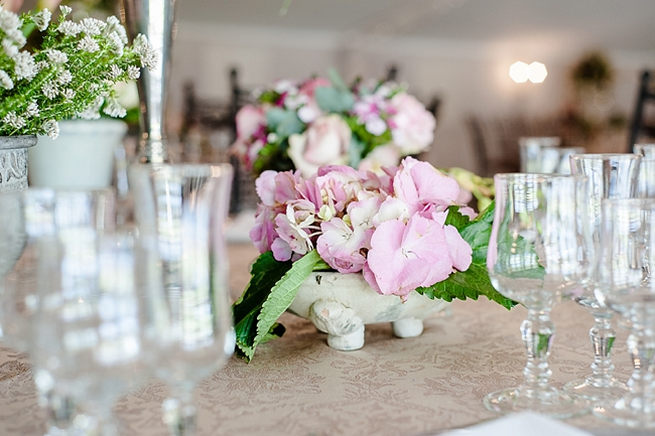 Blush and pink wedding flowers in silver urns and vases on wedding reception tables: hydrangea, pink and cream roses, lisanthius and leatherleaf ferns . So pretty for a spring wedding // D’amor Photography