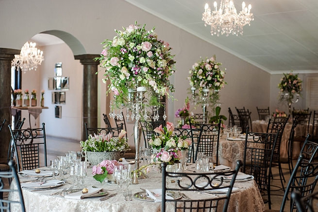 Blush and pink wedding flowers in silver urns and vases on wedding reception tables: hydrangea, pink and cream roses, lisanthius and leatherleaf ferns . So pretty for a spring wedding // D’amor Photography