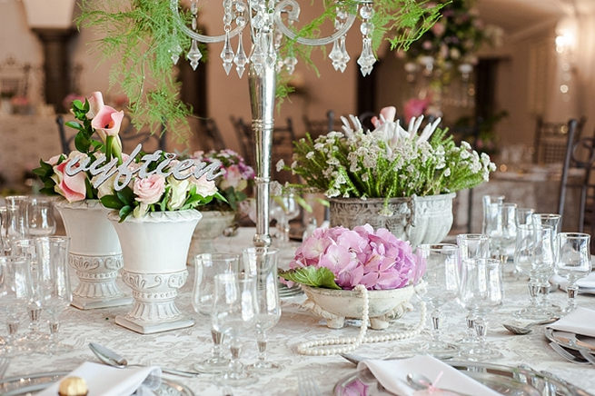 Blush and pink wedding flowers in silver urns and vases on wedding reception tables: hydrangea, pink and cream roses, lisanthius and leatherleaf ferns . So pretty for a spring wedding // D’amor Photography