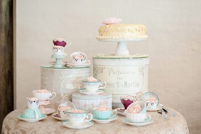 Whimsical cake table in pastel shades with teacups and goods baked by brides mom. Lazer cut Mr and Mrs Signs. Blush Pink and Powder Blue Spring Wedding // D’amor Photography