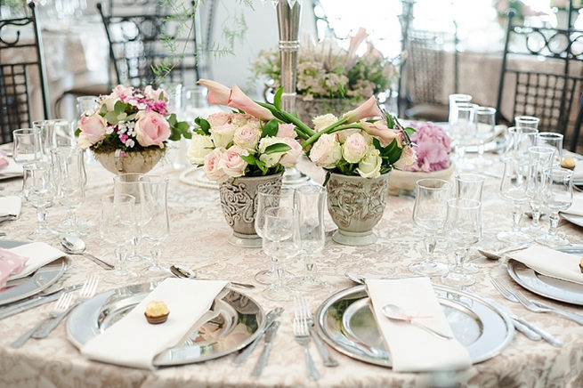 Blush and pink wedding flowers in silver urns and vases on wedding reception tables: hydrangea, pink and cream roses, lisanthius and leatherleaf ferns . So pretty for a spring wedding // D’amor Photography