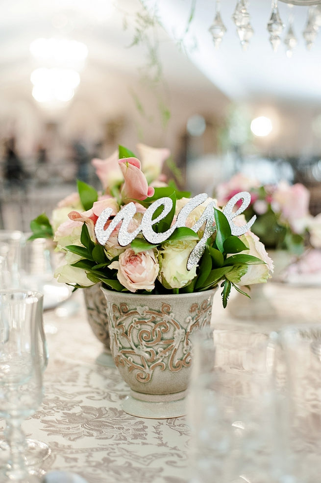 Blush and pink wedding flowers in silver urns and vases on wedding reception tables: hydrangea, pink and cream roses, lisanthius and leatherleaf ferns . So pretty for a spring wedding // D’amor Photography