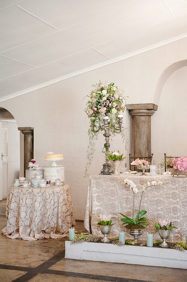 Blush and pink wedding flowers in silver urns and vases on wedding reception tables: hydrangea, pink and cream roses, lisanthius and leatherleaf ferns . So pretty for a spring wedding // D’amor Photography