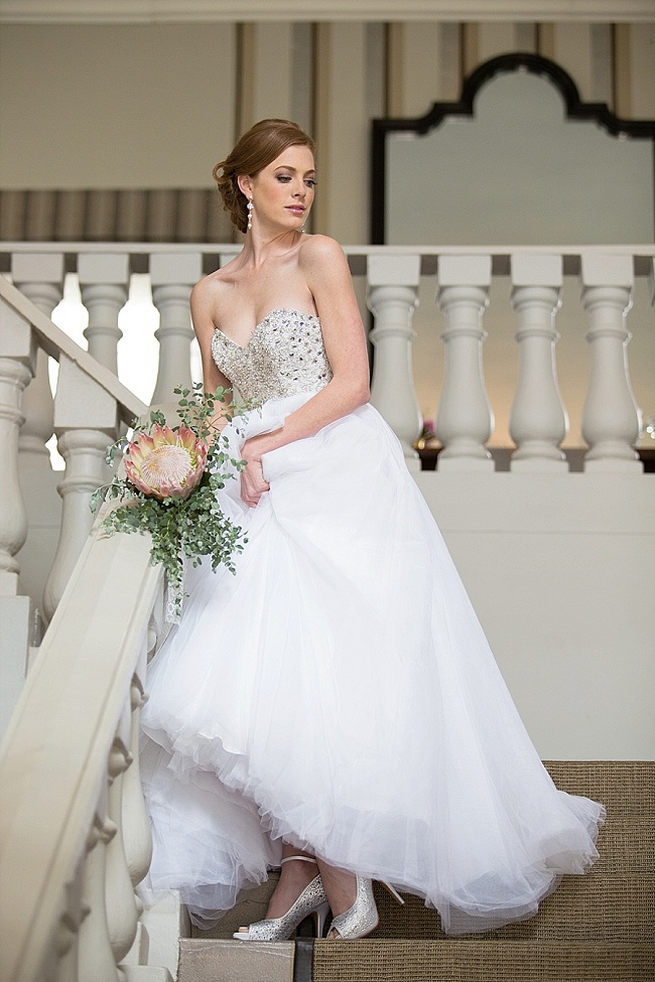 Beaded bodice and tulle skirt with King Protea wedding bouquet. Soft Pink and Gold Wedding by Samanatha Jackson Photo