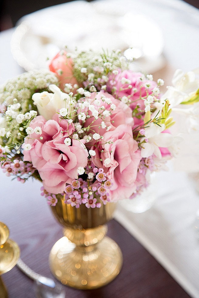 Wedding flower center piece: gold vase with babys breath, wild flowers and blush pink blooms. Soft Pink and Gold Wedding by Samanatha Jackson Photo