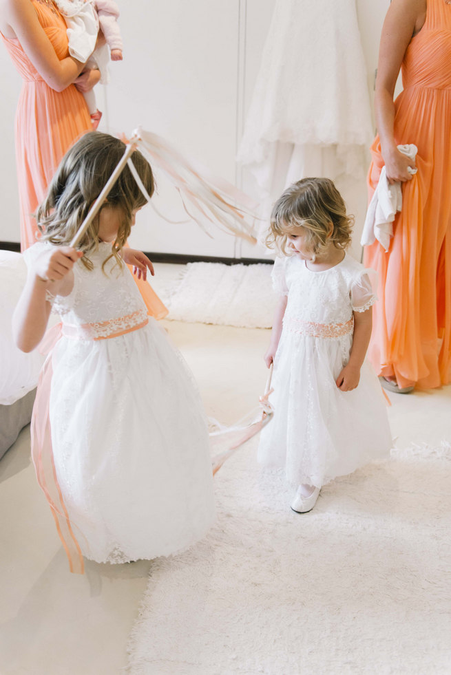 Flower girls in white dresses with ribbon wands and babys breath flower crown wreaths // Succulent Garden Wedding // Claire Thomson Photography