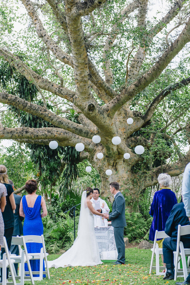 Wedding ceremony under a gorgeous old tree with white chinese lanterns // Succulent Garden Wedding // Claire Thomson Photography