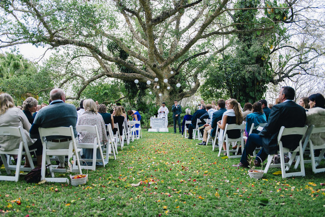 Wedding ceremony under a gorgeous old tree with white chinese lanterns // Succulent Garden Wedding // Claire Thomson Photography