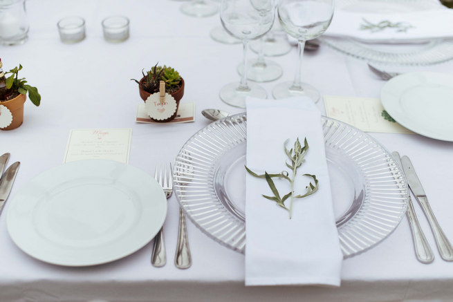 White linen, clear glass charger underplate, napkin and herb place setting with succulent favors // Succulent Garden Wedding // Claire Thomson Photography