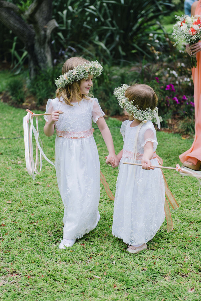 Flower girls in white dresses with ribbon wands and babys breath flower crown wreaths // Succulent Garden Wedding // Claire Thomson Photography