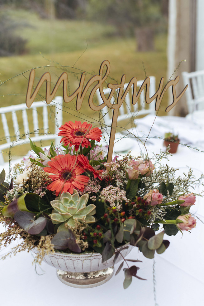 Succulent centerpiece arrangement with lazer cut Mr and Mrs Sign // Succulent Garden Wedding // Claire Thomson Photography