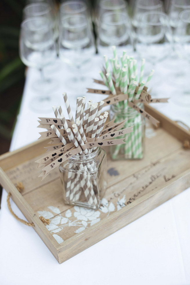 Distressed wooden tray with striped paper straws and drink flags