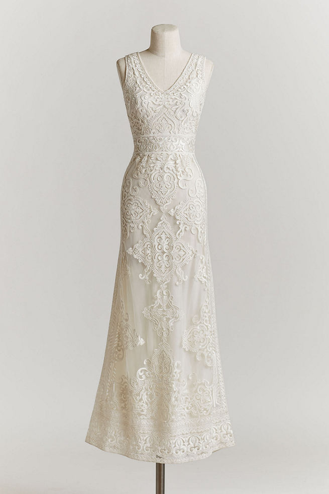 Vintage Wedding Dress: This delicate, ivory tulle gown features a plunging-v neckline and filigreed embroidery throughout the bodice and column skirt.