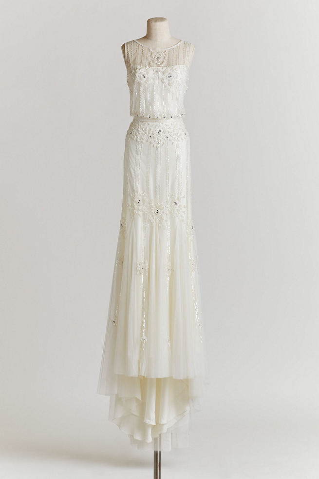 Vintage Wedding Dress: The Magnolia gown features a sheer neckline, and a layered skirt of delicate, gauzy tulle, in a beaded ivory fabric with a deep-v back