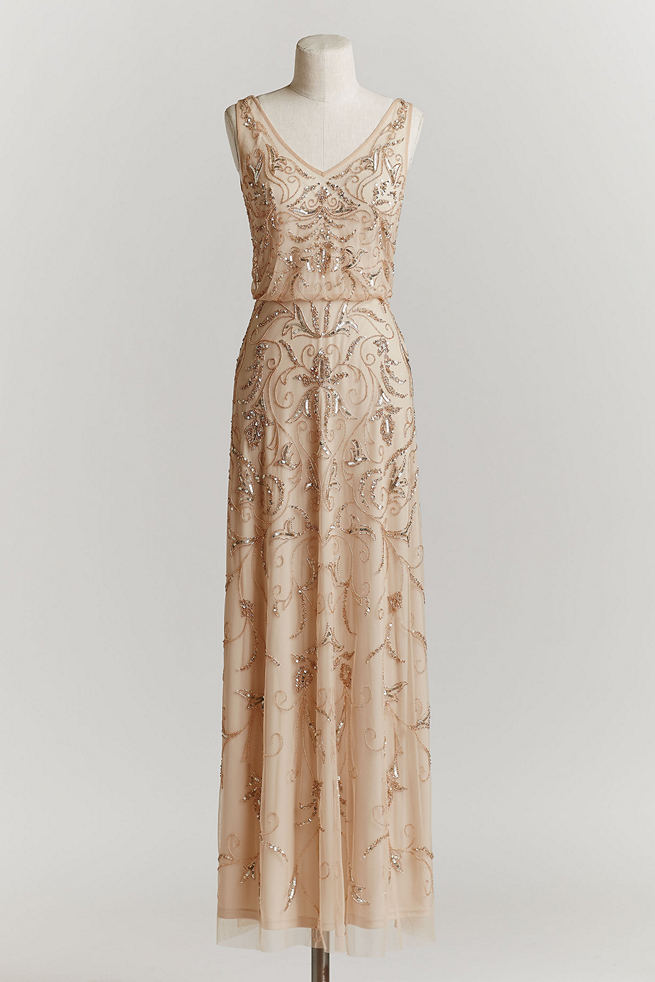 Vintage Wedding Dress: With a blouson silhouette and beads and sequins stitched upon champagne tulle, this vintage wedding dress evokes the era of brass bands and unbridled extravagance