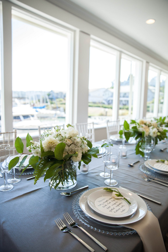 Hand calligraphed menu by Steele My Hear, place setting on clear glass charger and elegant fresh florals by Angel's Petals. Elegant Gray Blue Nautical Wedding by Rachel Capil Photography and Lindsay Lauren Events