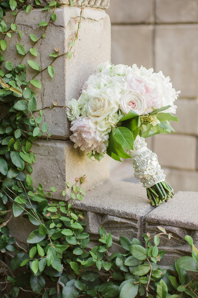 All white wedding bouquet of white roses, white hydrangea, white peony and pale blush roses.  