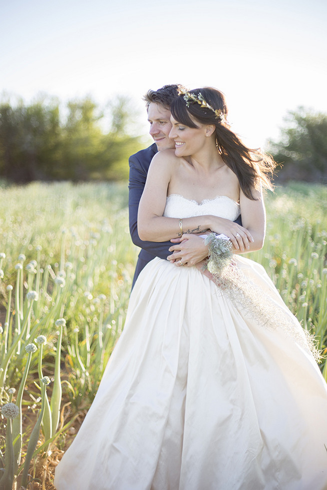  Couple wedding photographs in a field of onion flowers // Organic Farm Style Karoo Wedding // christine Le Roux Photography