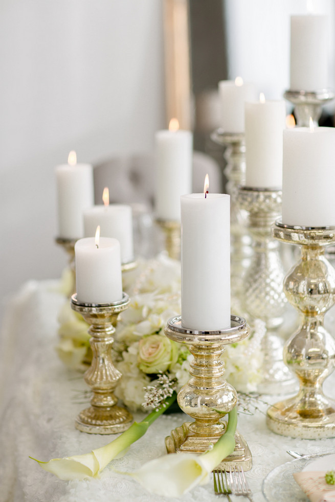 Gorgeous pillar candles. Super chic sweetheart table! White on White Glamorous Wedding Ideas by ENV Photography. Styled by Elegant Touches and Atmosphere Weddings