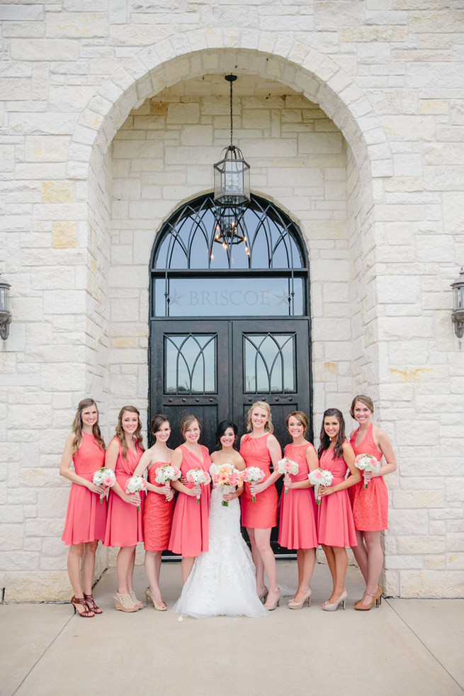 Short matching coral bridesmaid dresses with peach and white bridesmaid bouquets. Cute Coral Gray wedding at Briscoe Manor, Houston, by Luke and Cat Photography