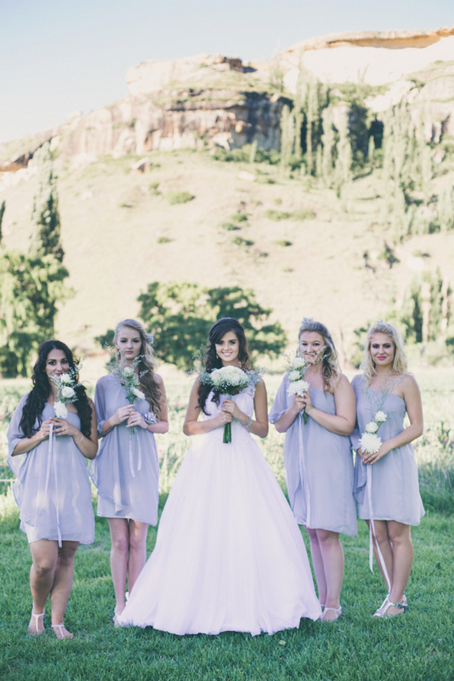 Bridesmaid in grey off the short short dress and three white flowers. Grey White Farm Wedding, South Africa // Maryke Albertyn