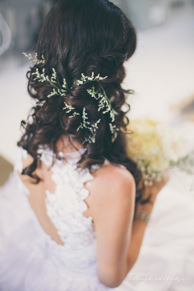 Amazing wedding hair style with long loose curls and a wrap around braid detail and sprigs of babys breath. So pretty!