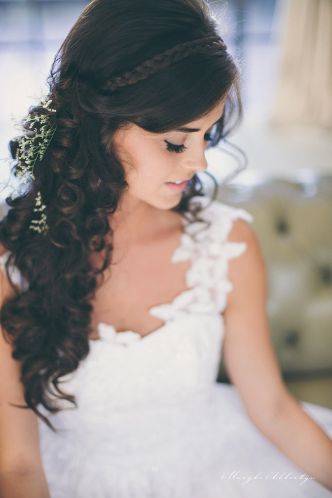 Amazing wedding hair style with long loose curls and a wrap around braid detail and sprigs of babys breath. So pretty!