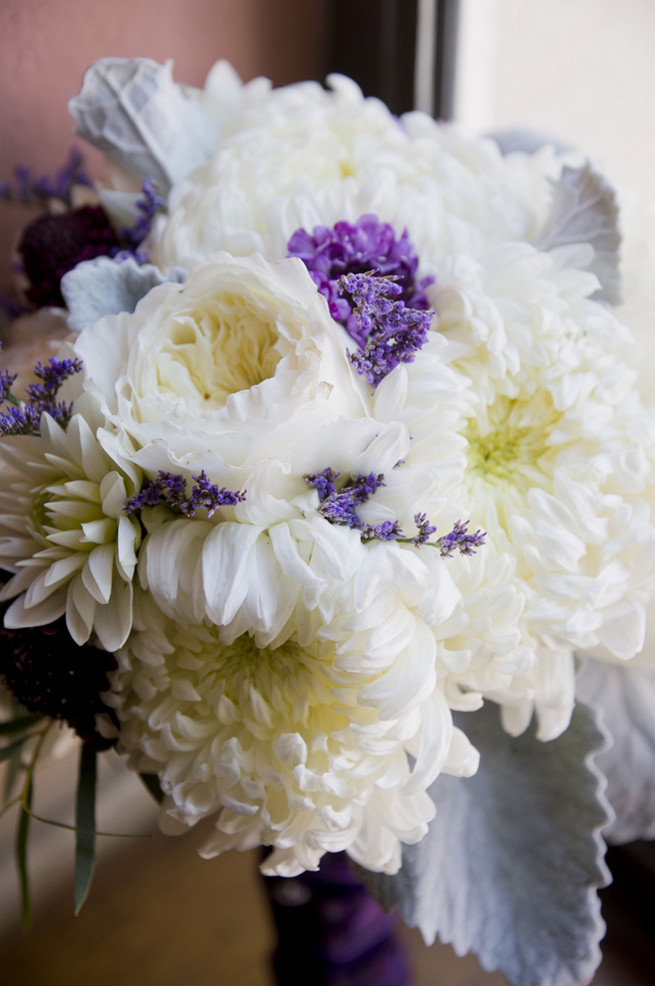 White chrysanthemums, white garden roses, lambs ear and purple filler flowers bridal bouquet