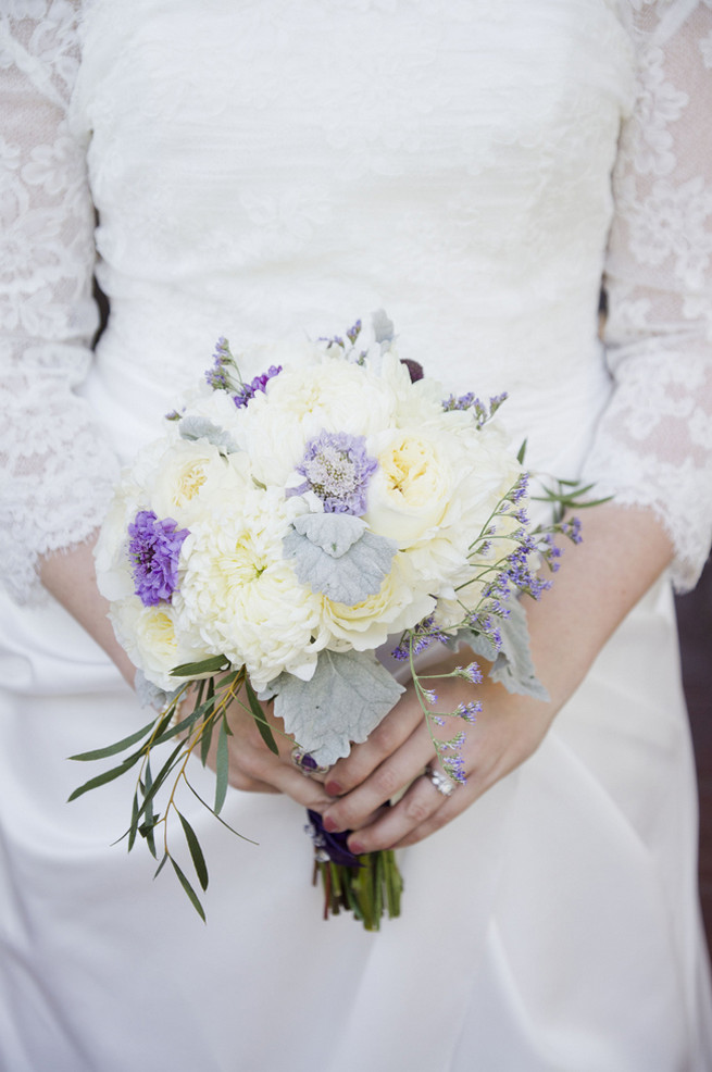 White chrysanthemums, white garden roses, lambs ear and purple filler flowers bridal bouquet