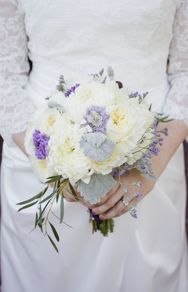 White chrysanthemums, white garden roses, lambs ear and purple filler flowers bridal bouquet