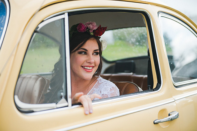 Bride arriving in vintage Volkswagen Beetle. Woodlands Winter Wedding in deep blue, burgundy and emerald green // Knit Together Photography