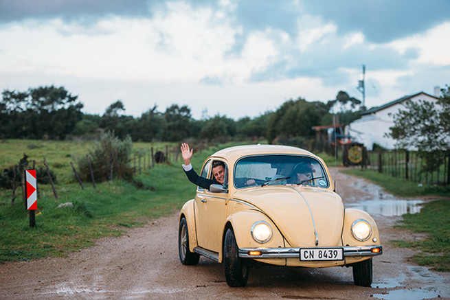  Bride and groom leaving in vintage Volkswagen Beetle. Woodlands Winter Wedding in deep blue, burgundy and emerald green // Knit Together Photography