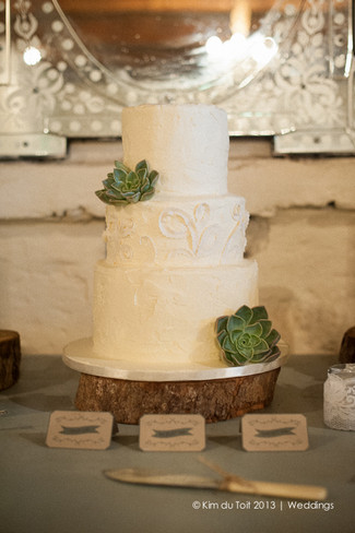 All white wedding cake with succulents