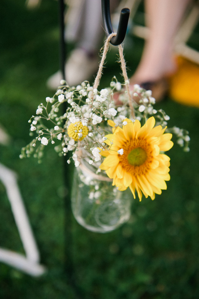 Sunflower and babys breath aisle flowers in jar.  Coral Navy Mustard Wedding / Meredith McKee Photography