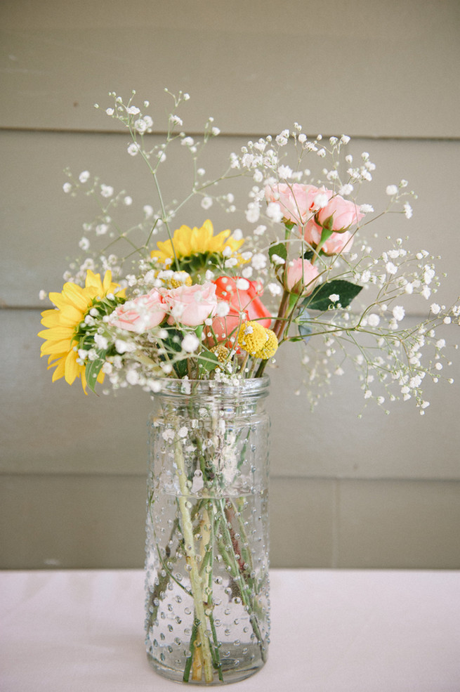 Milkbottle with sunflowers, gerberas and babys breath.  Coral Navy Mustard Wedding / Meredith McKee Photography