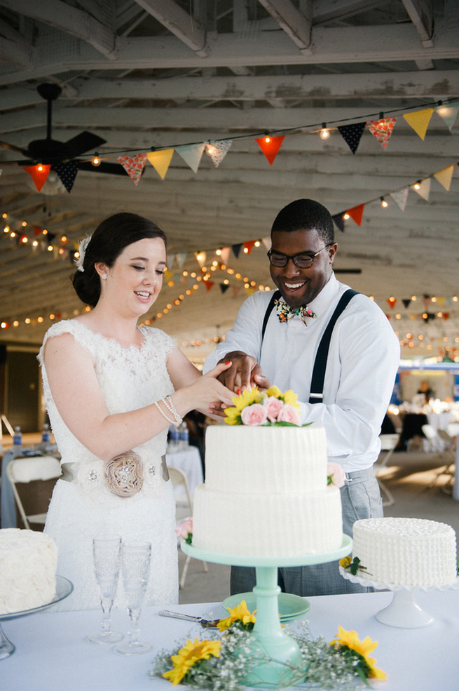 Cake cutting.  Coral Navy Mustard Wedding / Meredith McKee Photography